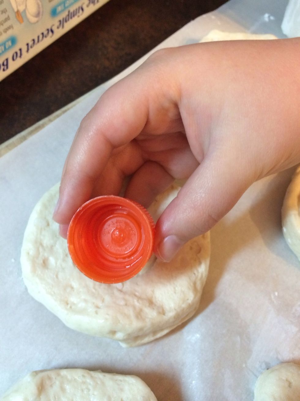 Ethan has a bottle top to cut out the hole.