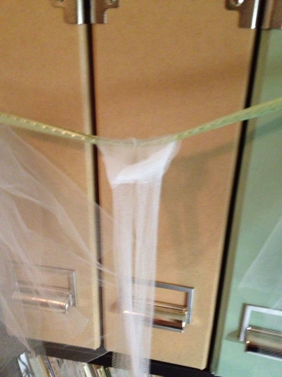 Even out ends and tighten. Push to one side of ribbon or work next to it.