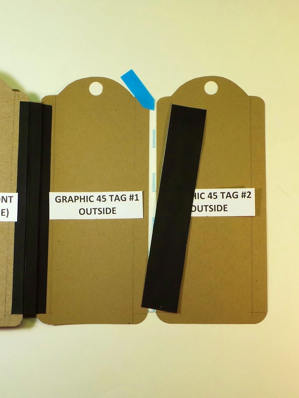 Even though there is not a chipboard spine to cover between the two paper tags, you will finish the "spine" as if there were. Don't forget to remove the Scor-Tape backing from the 1st Tyvek strip!