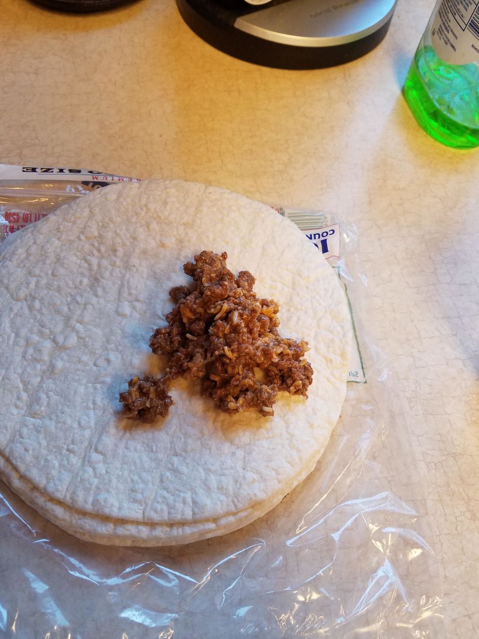 evenly add the meat to the tortillas