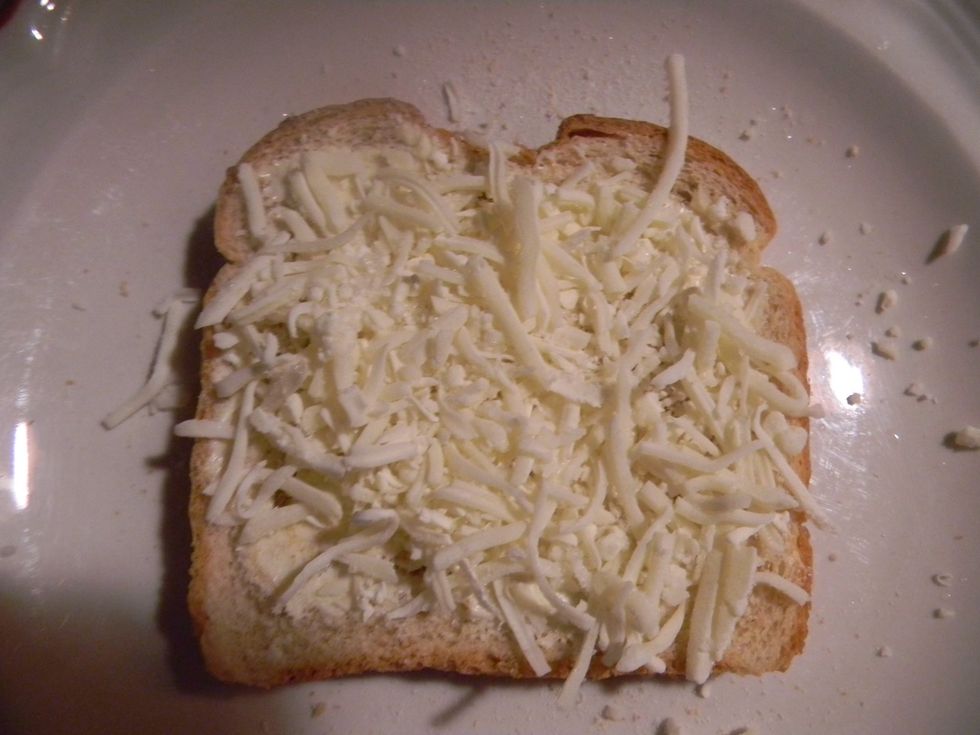 Evenly apply mozzarella cheese to the buttered side.