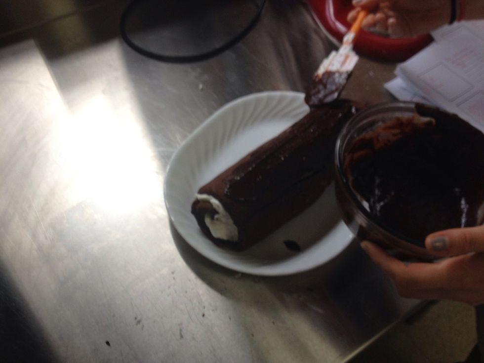 Evenly apply the chocolate sauce to the top and sides of your cake roll.