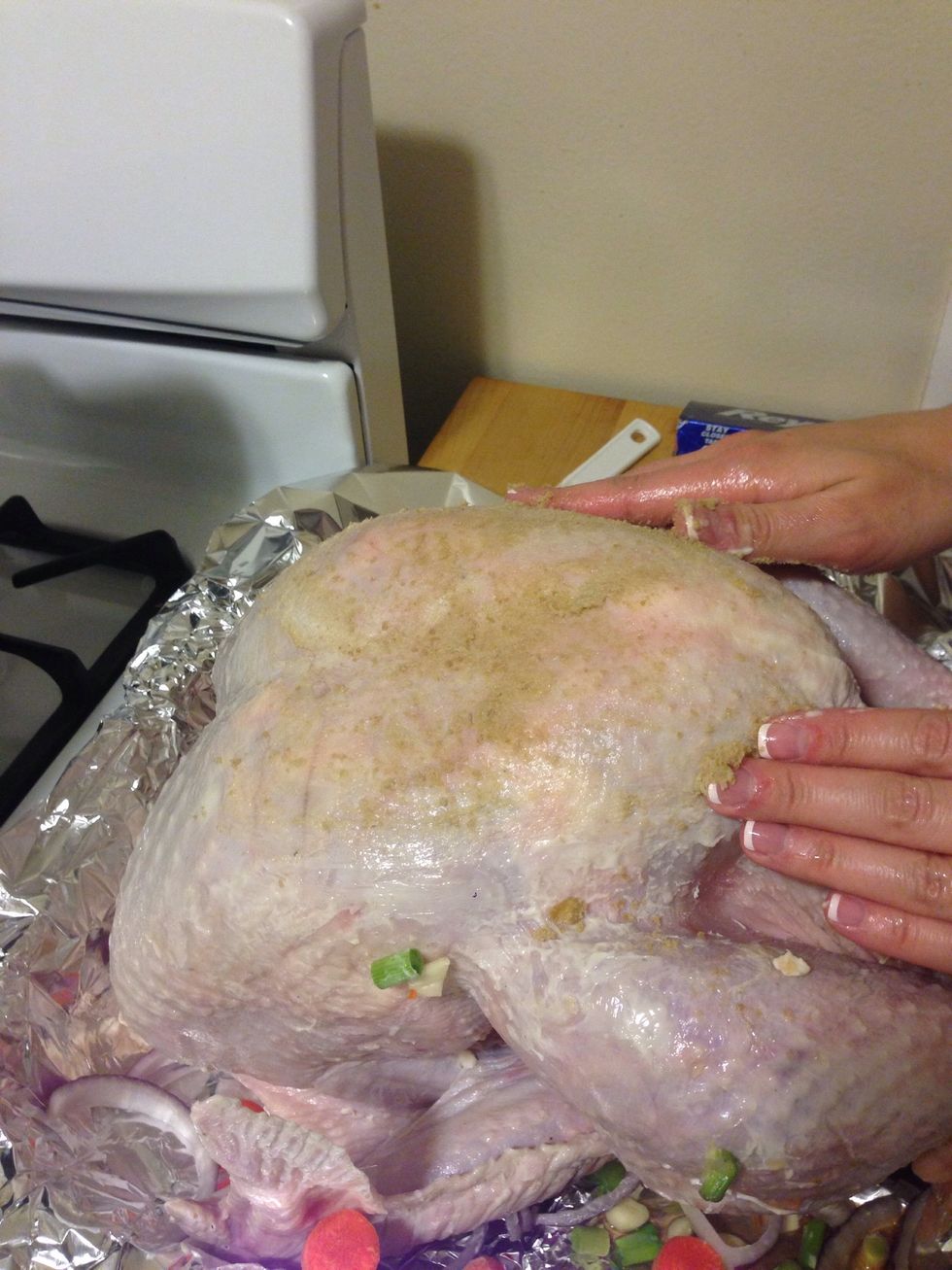 Evenly coat the entire turkey with the brown sugar.