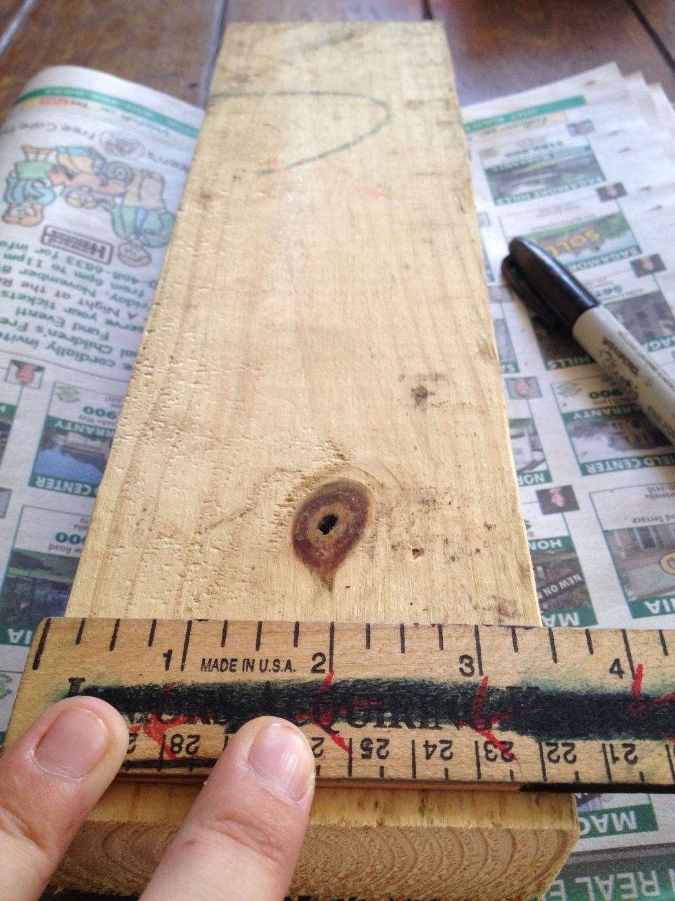 Evenly space out marks for three nails to be placed across the width of your board. Not too close to the edge.