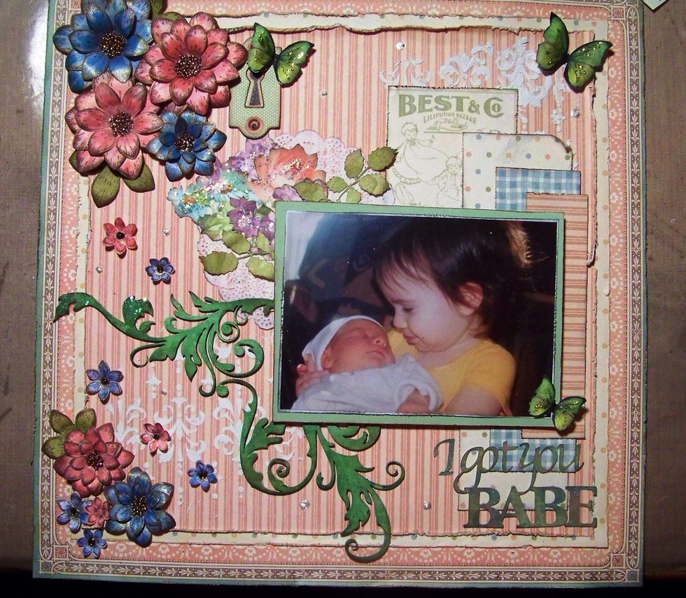 Everything gets glued down, I pop my pic on foam for height. My flower centers are filled with micro-beads, I add some stickles for sparkle and liquid pearls randomly around the layout.