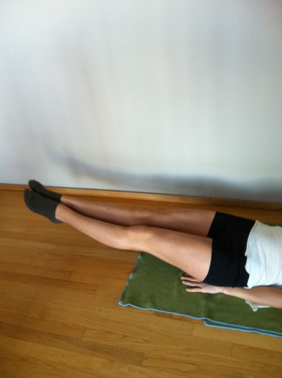 Exercise two: six inches. Lie on your back with your arms under your butt for support and lift your legs about six inches off the ground and hold. Your head should be up too.