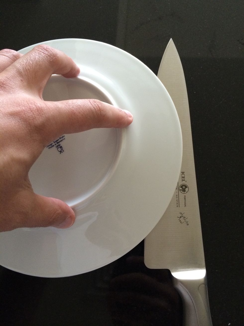 Exert uniform pressure to hold all the grapes still, don't press too much to avoid squishing the fruits - cut through the gap with a sharp knife