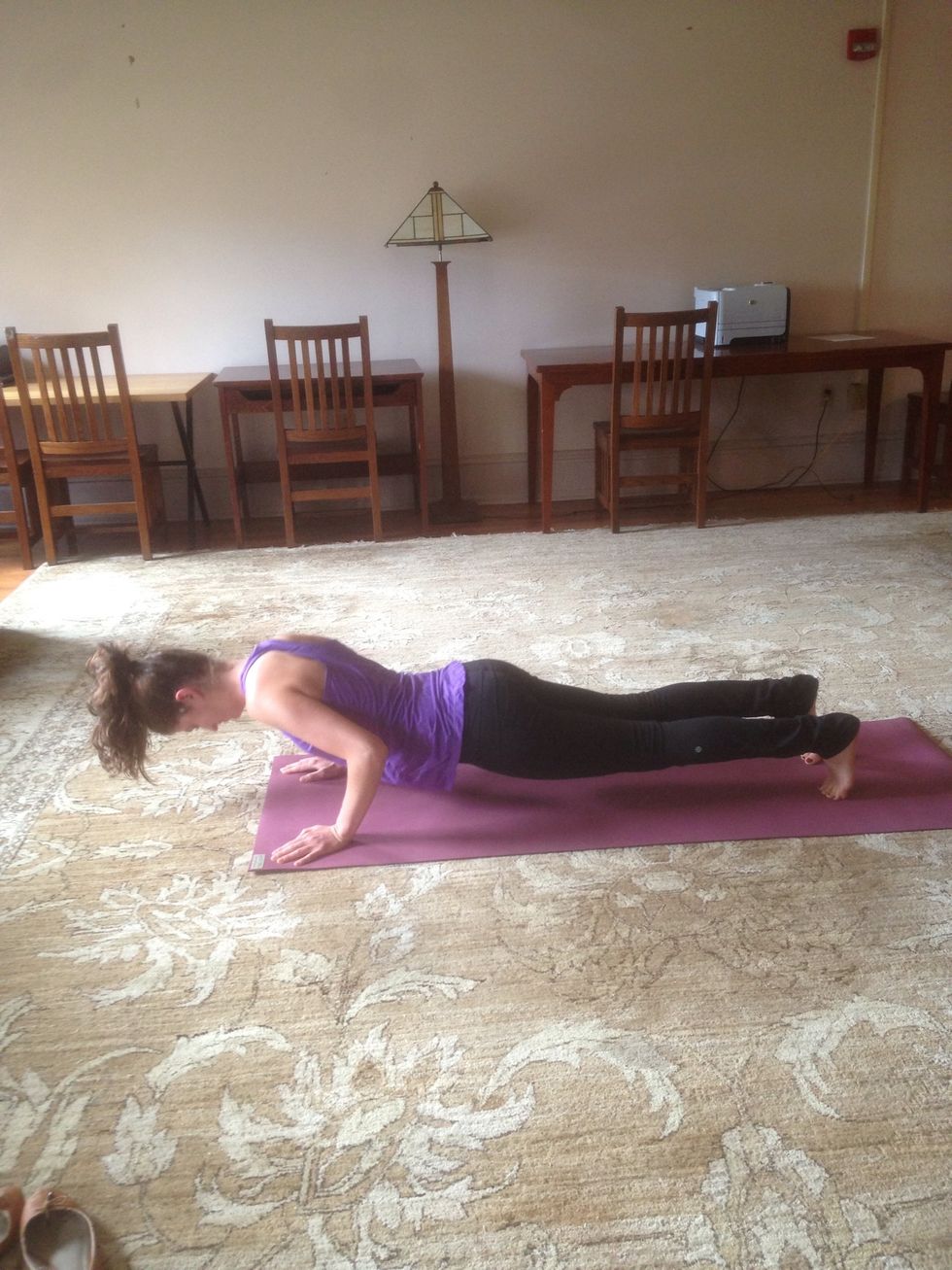 Exhale and step or jump back in to Chaturanga (low push-up). Elbows tucked in to sides and feel triceps supporting the body as it lowers down to ground.