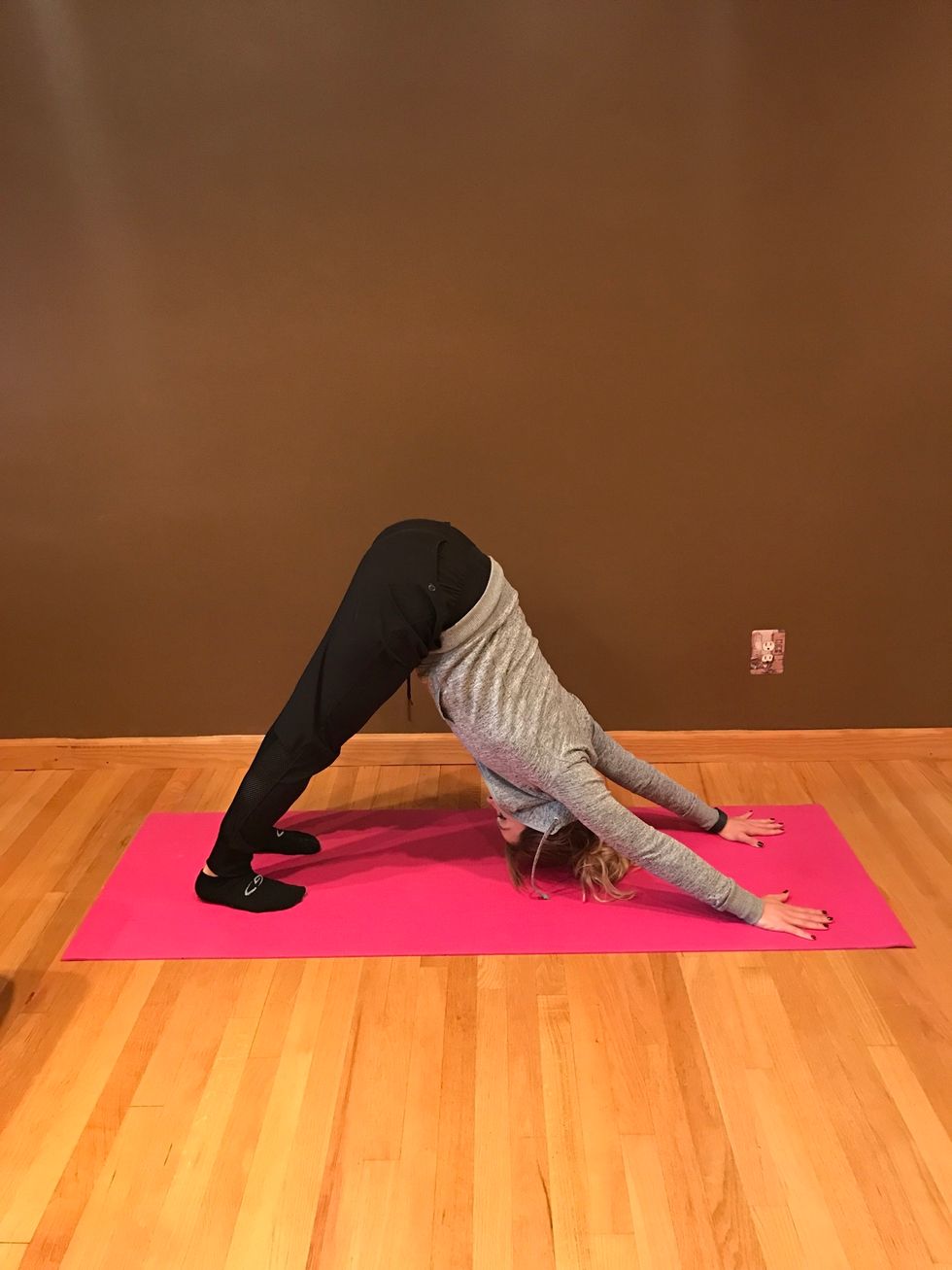 Exhale into downward dog. Push hips as far up as you can, heels should be reaching for ground. Arms are straight as you look at your stomach.