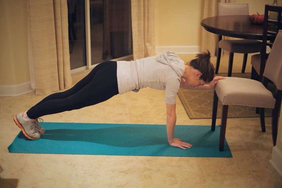 Extended Arm Lizard Walk: Extend one arm to seat of chair wile in plank position.
