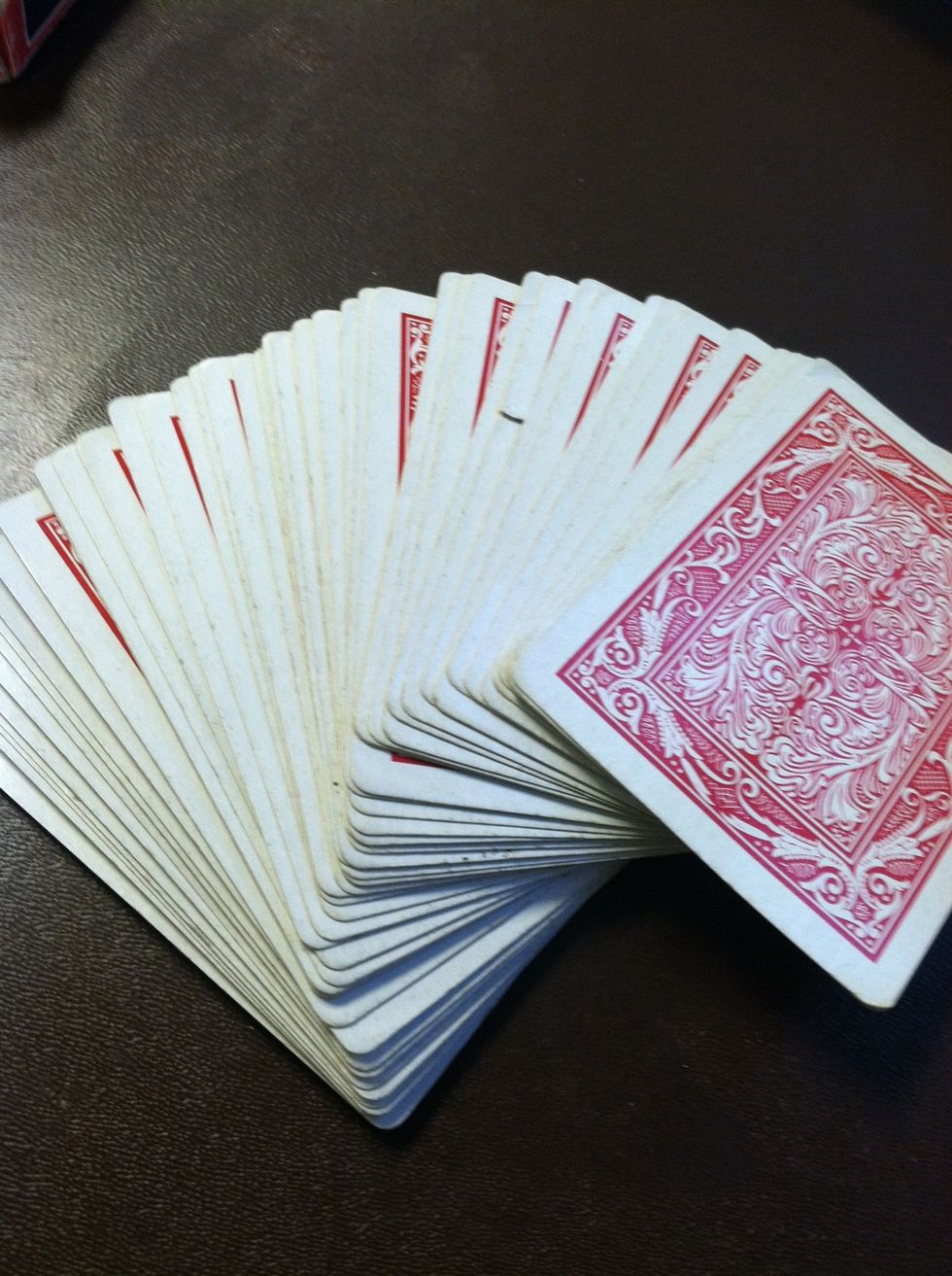 Fan out the cards and have someone pick a card and look at it without showing it.