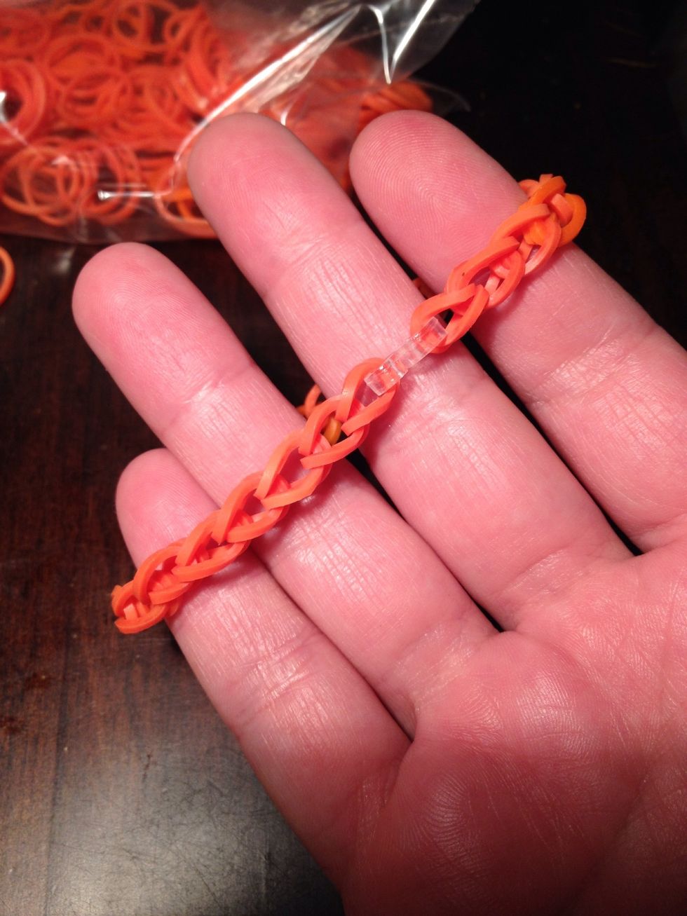 Fasten with plastic fastener piece. This is a plain elastic band bracelet, not a fishtail. A Snap Guide is available for this, too, under my guide list. Have fun!