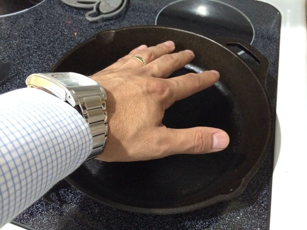 Feel the pan and wait for its hottest point.