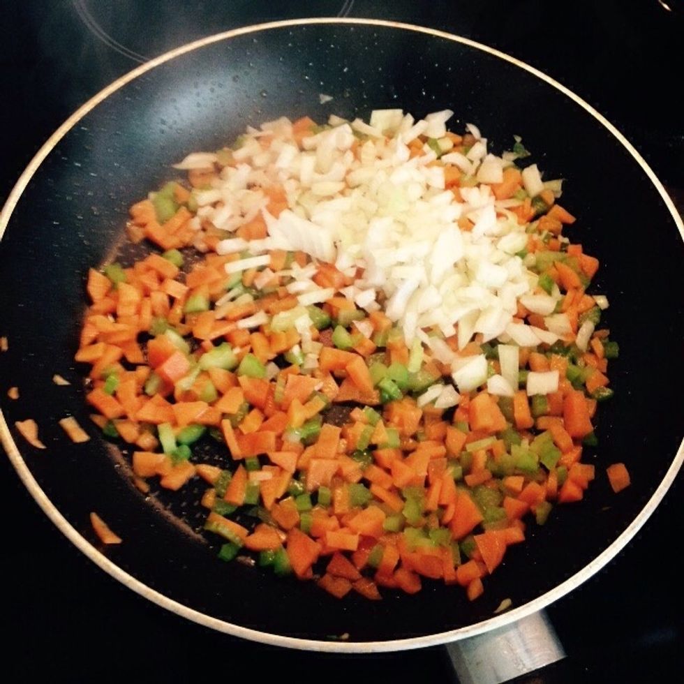 Few minutes later add the onion as well. Stir everything in and lower the heat.