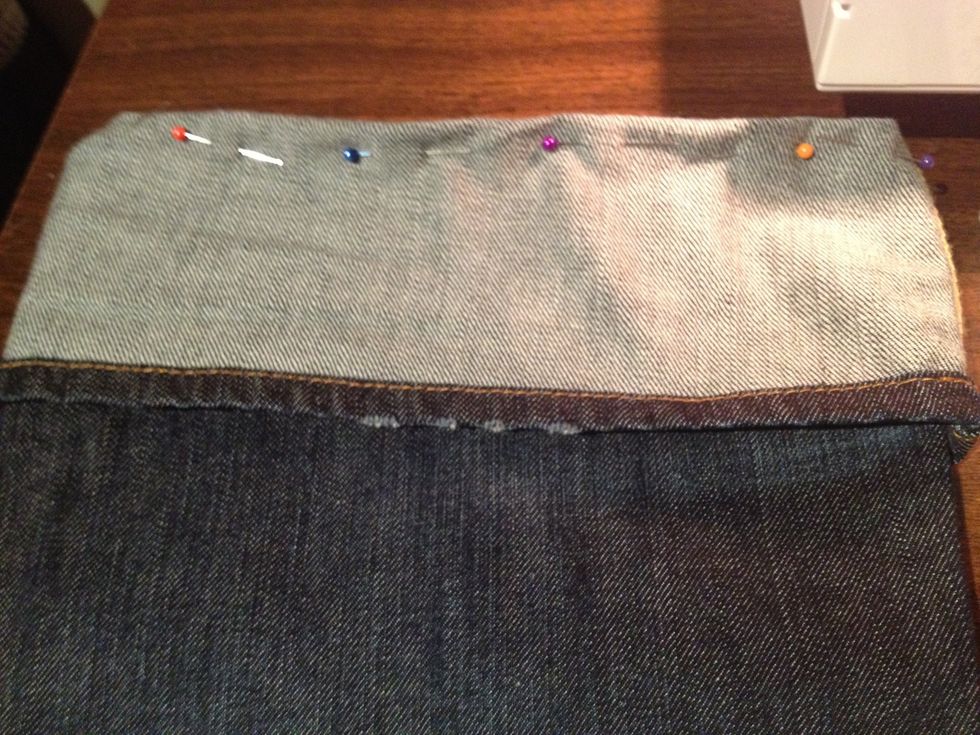 Figure out how much length you want to take up on your jeans. Fold them up to where you want them. Try them on with shoes to make sure that length will work with your heels, boots, etc. Now pin.