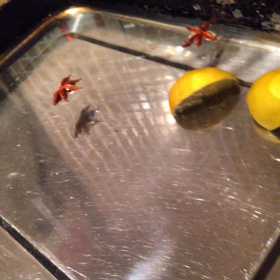 Fill a deep baking tray 3/4 with cold water, cut the lemon and throw it in with the Star anise. This part of the process stops the rack drying out and cooks the meat evenly.