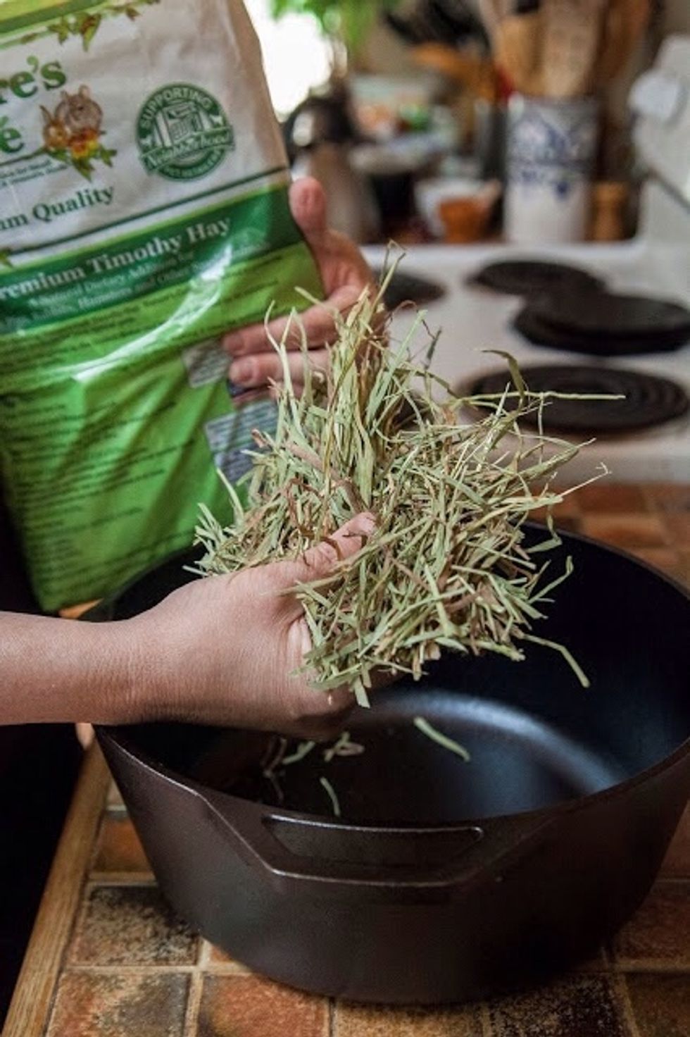 Fill a dutch oven or heavy oven-worthy pot, ( I used cast iron) with clean fresh alfalfa. The reason for using hamster fodder is for cleanliness.