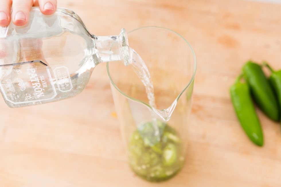 Fill a large jar with the jalape\u00f1o slices. Then, add tequila. We used a 375 ml bottle of Patron. Place in fridge and let infuse. We infused ours for about 6 hours, but you can let infuse for days.
