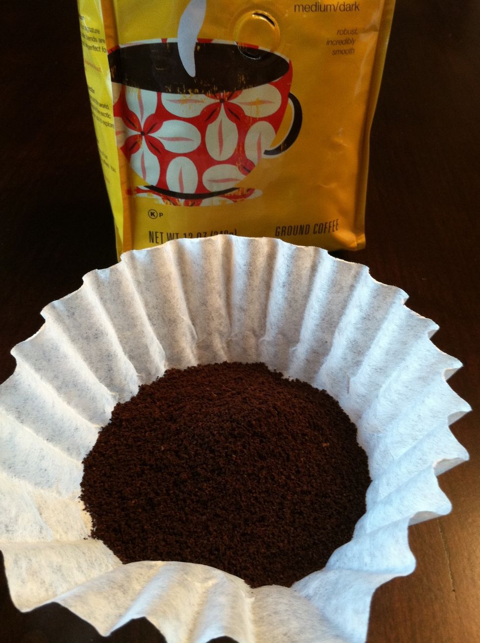 Fill a small basket style coffee filter with 2-3 teaspoons of your favorite ground coffee.