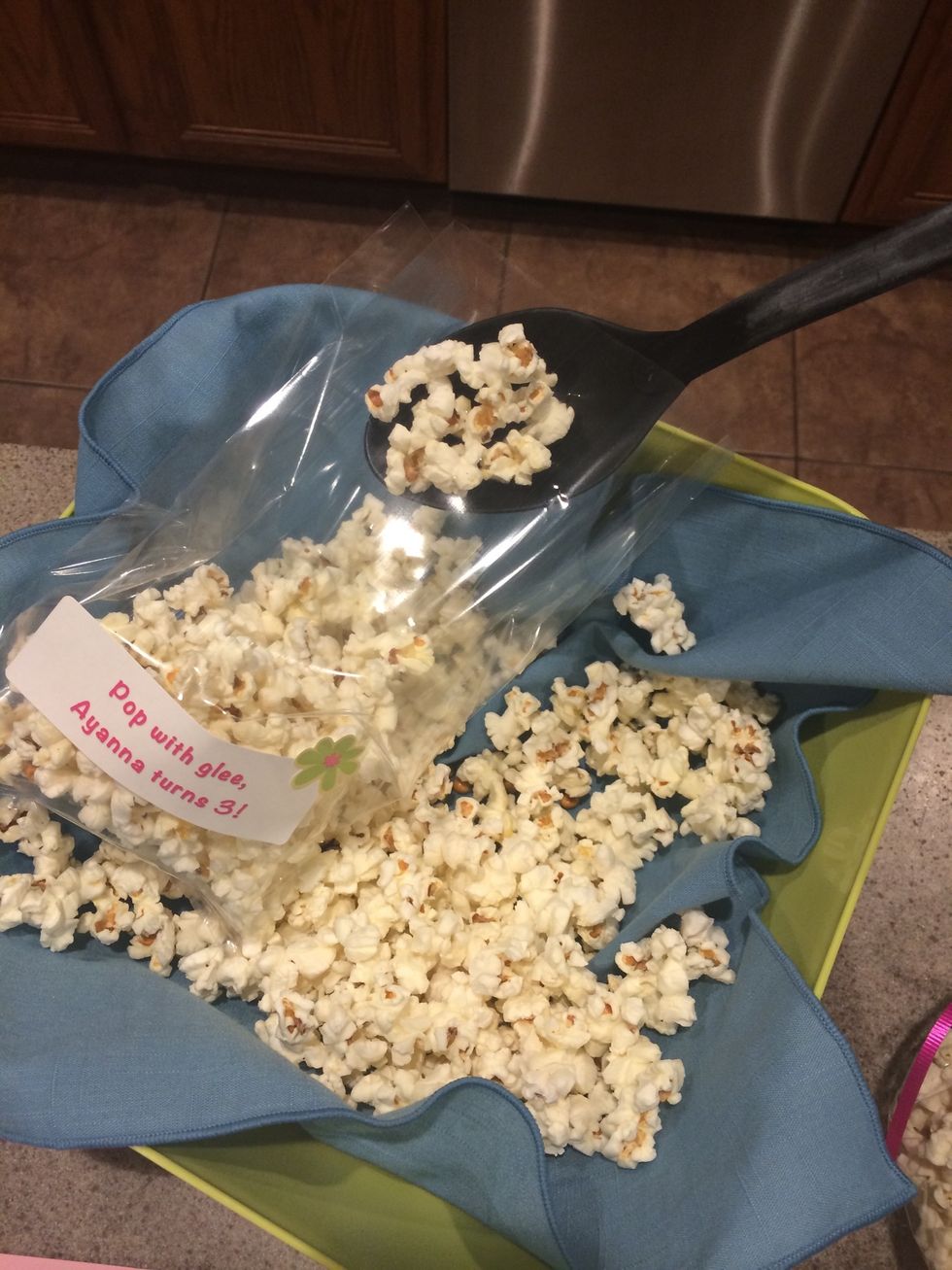 Fill bags a little less than half way with popcorn using large spoon or gloves (let's keep it sanitary for the kids) \ud83d\udc4d.