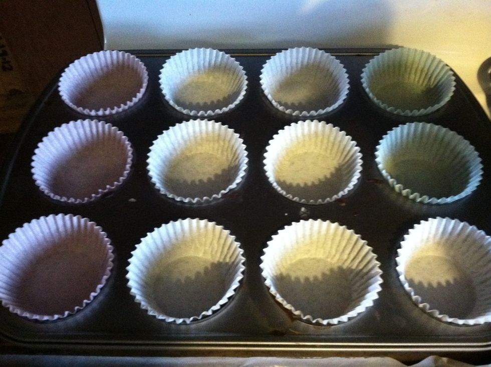 Fill cupcake tin with papers