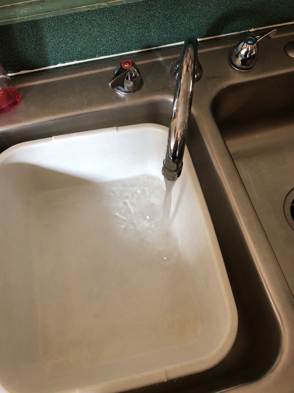 Fill dish tub with hot water