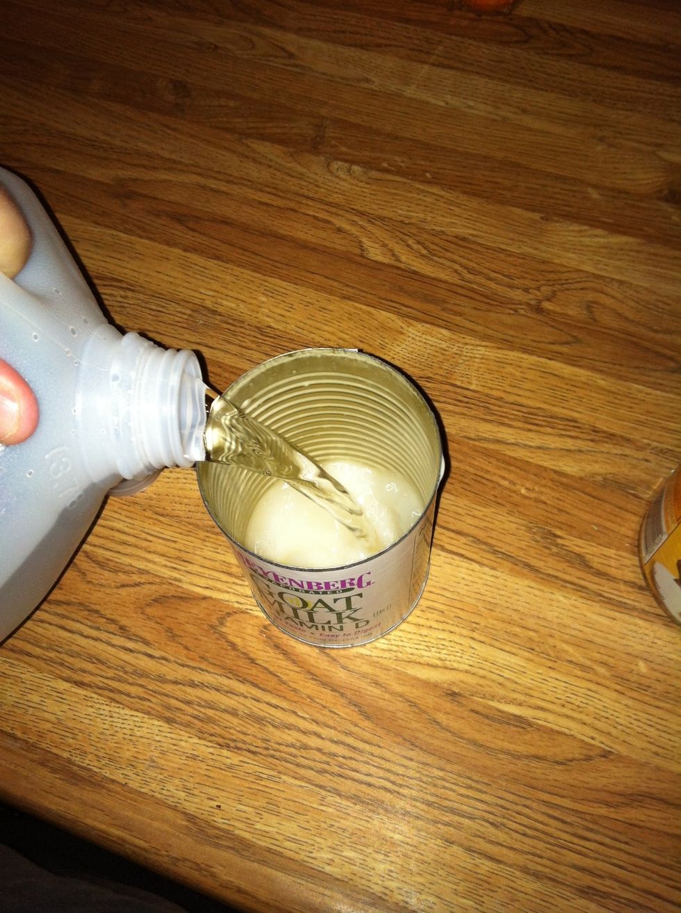 Fill goats milk can with purified water