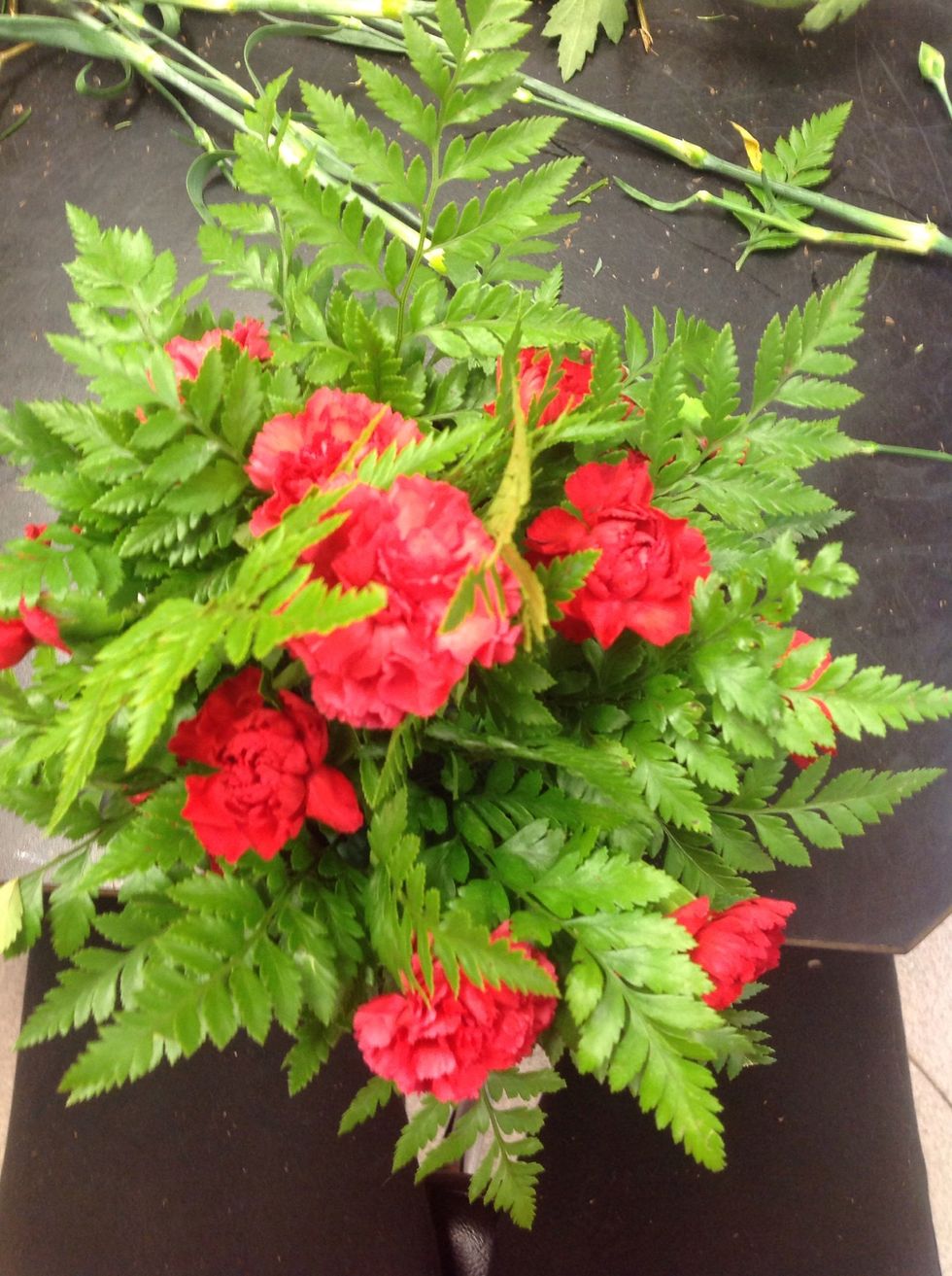 Fill in some spaces on the floral foam, leaving room for your secondary flower and filler.