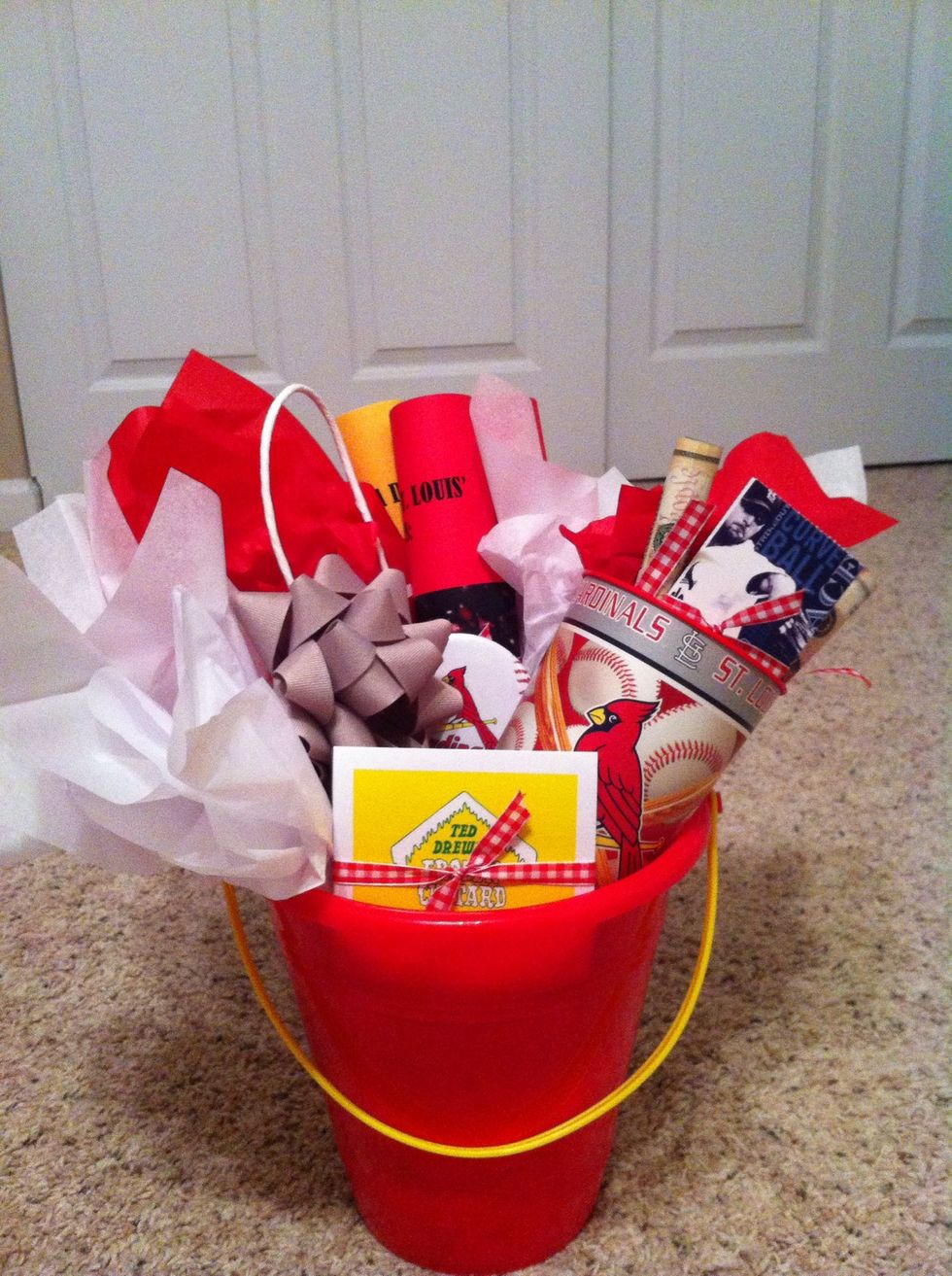 Fill in your bucket however you would like! I went with a St. Louis Theme. 2 Cardinals Tickets, a gift card to a restaurant on The Hill, and a gift card to Ted Drew's.