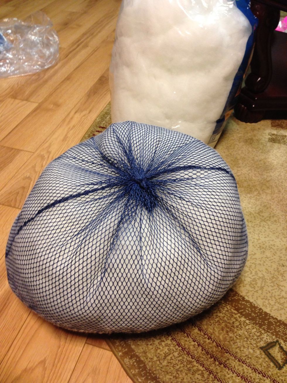 Fill laundry bag with quilt stuffing. Pull out the string and tighten to proper size