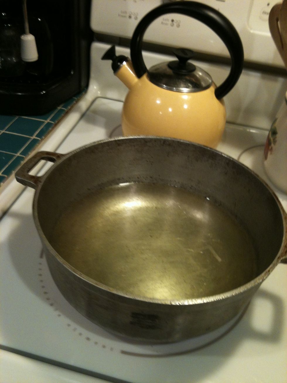 Fill pot half way with vegetable oil and turn burner on medium-high