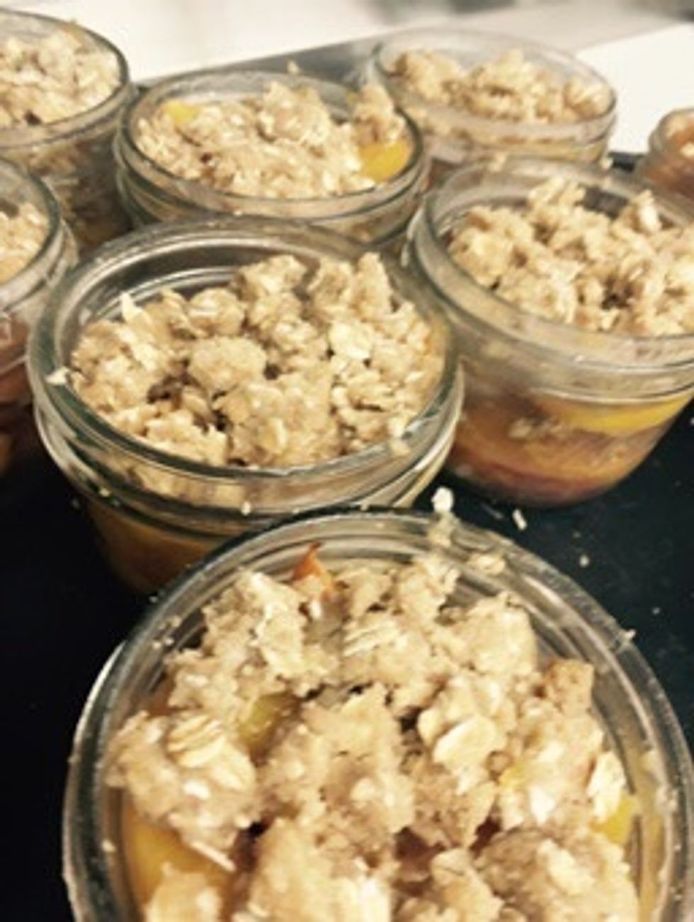 Fill remaining cups with peaches and finish with crumble topping.