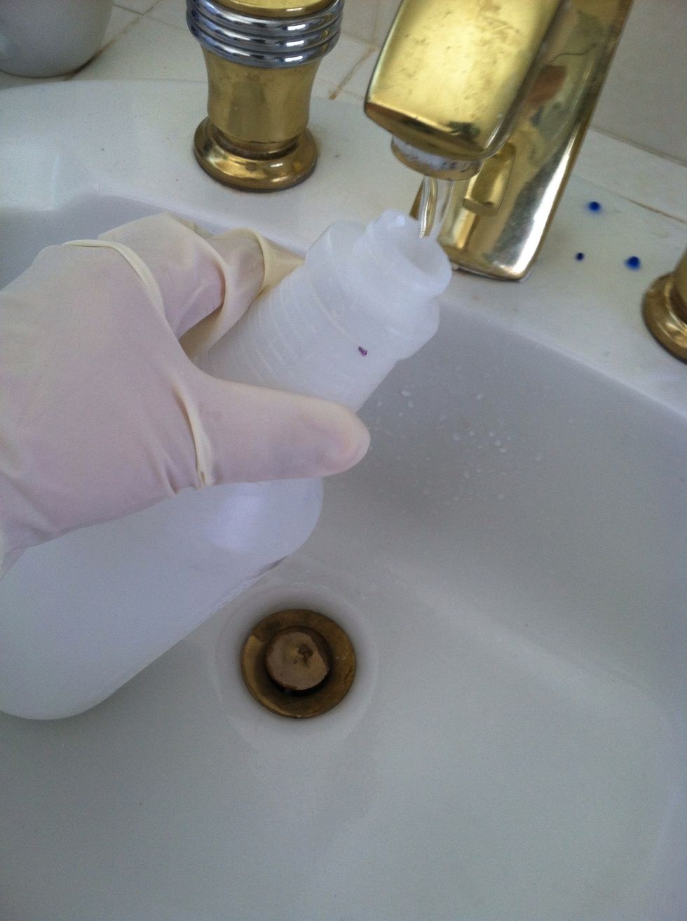 Fill spray bottle with water.