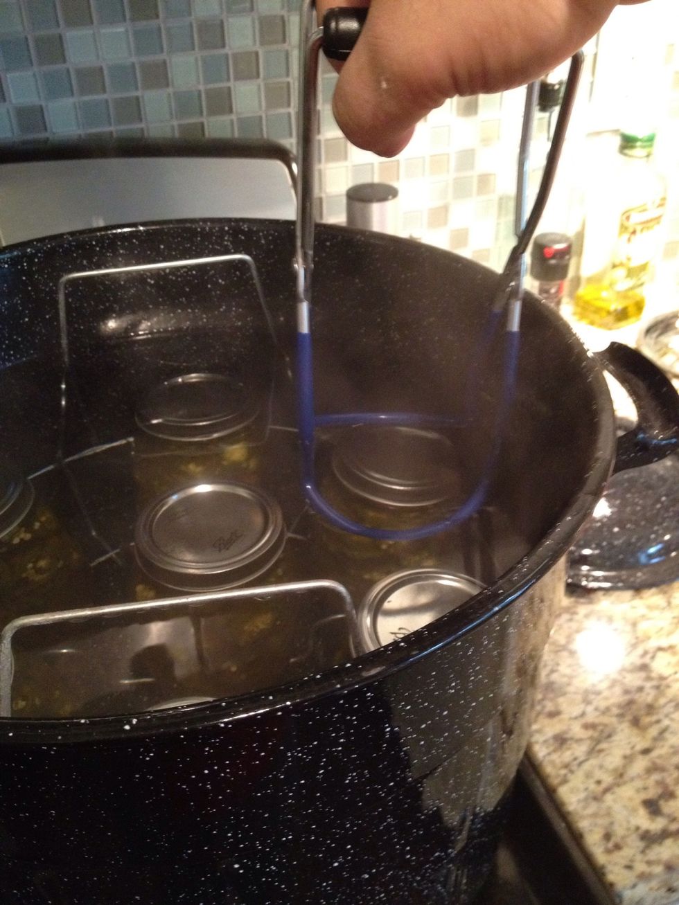 Fill stock pot with water and place the jars into the stock pot. Make sure the jars are submerged under water by 2 inches. Don't forget to include the jar with just the syrup!
