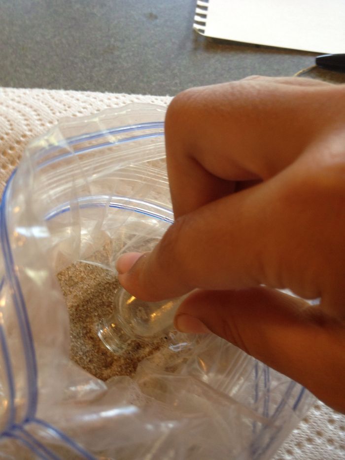 Fill the bottle with sand. You can do a scoop method, which I used, or make a funnel.