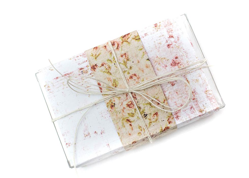 Fill the box with candy, a gift card, or any other gift. Adhere the paper to the box. Flip same paper over and score in the same spots to adhere to the middle of the box. Tie with Prima jute twine.