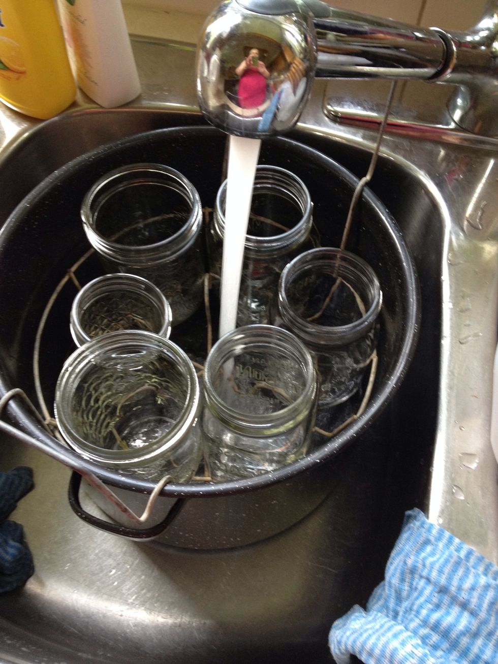 Fill the canner with enough water to almost cover the jars. Don't actually put the jars in like I did. Start heating up the canner. It will take a while.
