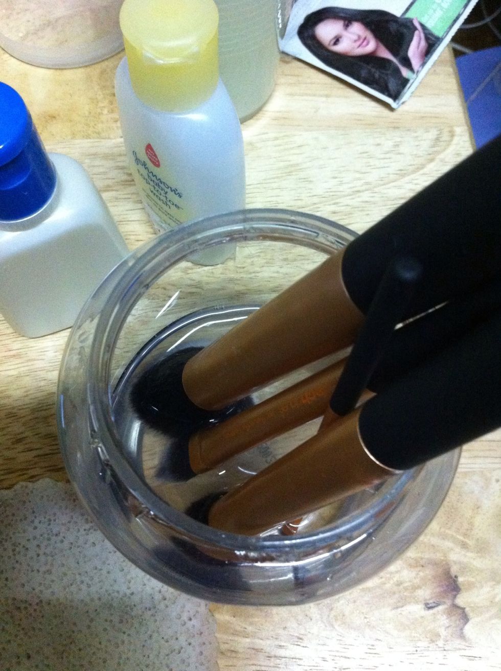 Fill the clear container with warm water. Again, pour just enough water to wet the bristles. Avoid wetting the part where the bristles are attached to the handle. Rinse.