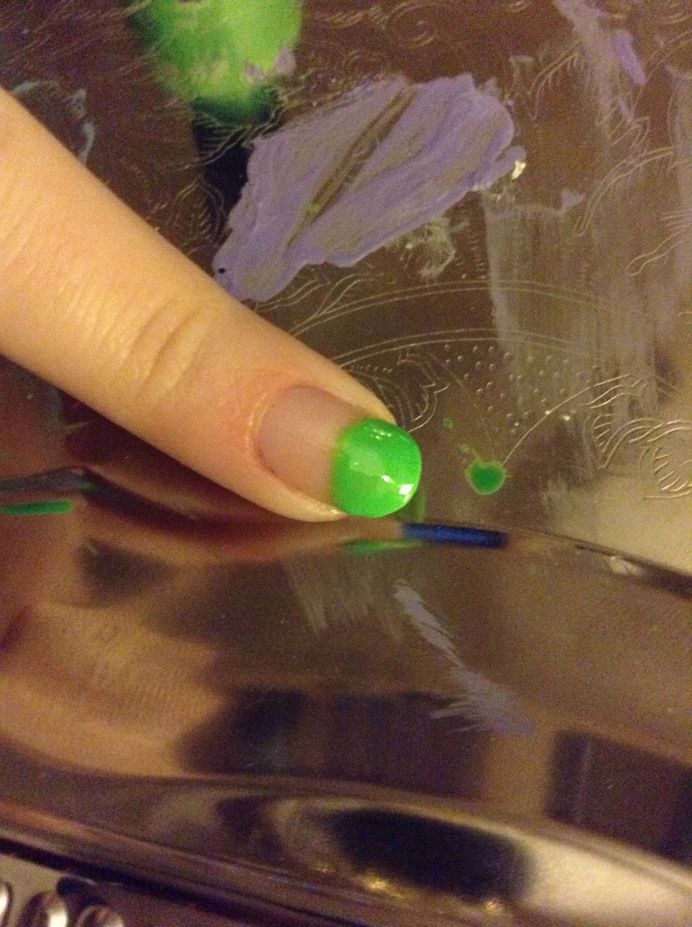 Fill the half circle in with the green polish. This may take two coats. This is the head of your alien.