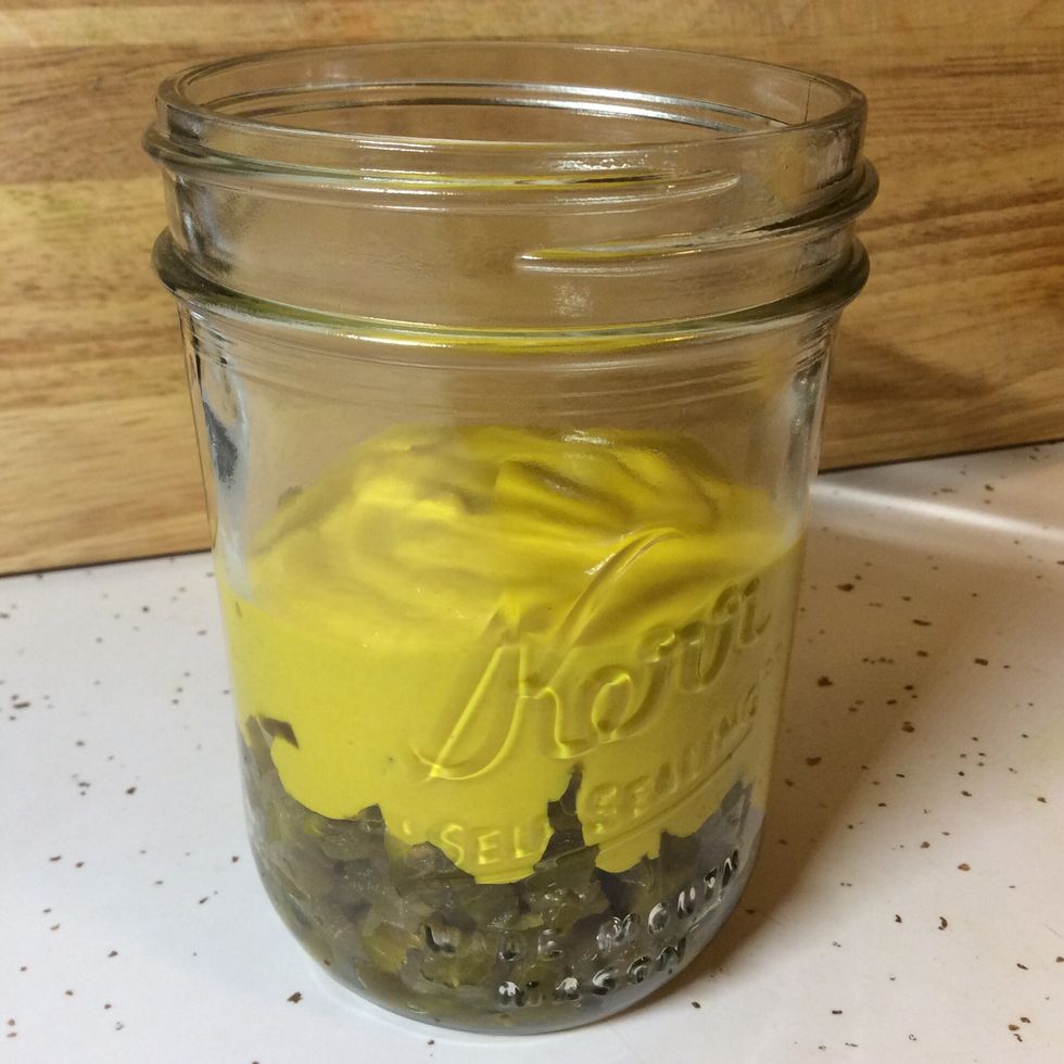 Fill the jar halfway and go ahead and mix it. This will make it easier to evenly distribute the jalapenos when you add the rest of the mustard.