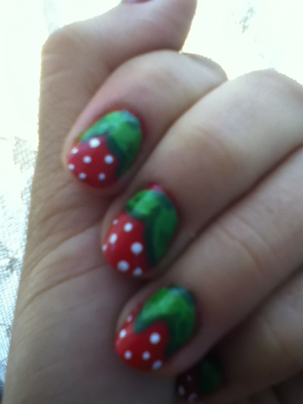 Fill the leaves with the green polish Outline them with a darker green and add some white dots for the seeds of the strawberry!