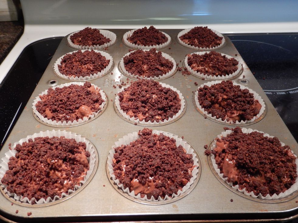 Fill the muffin cups up to the rim and top each one off with a tablespoonful of the crumb mixture.