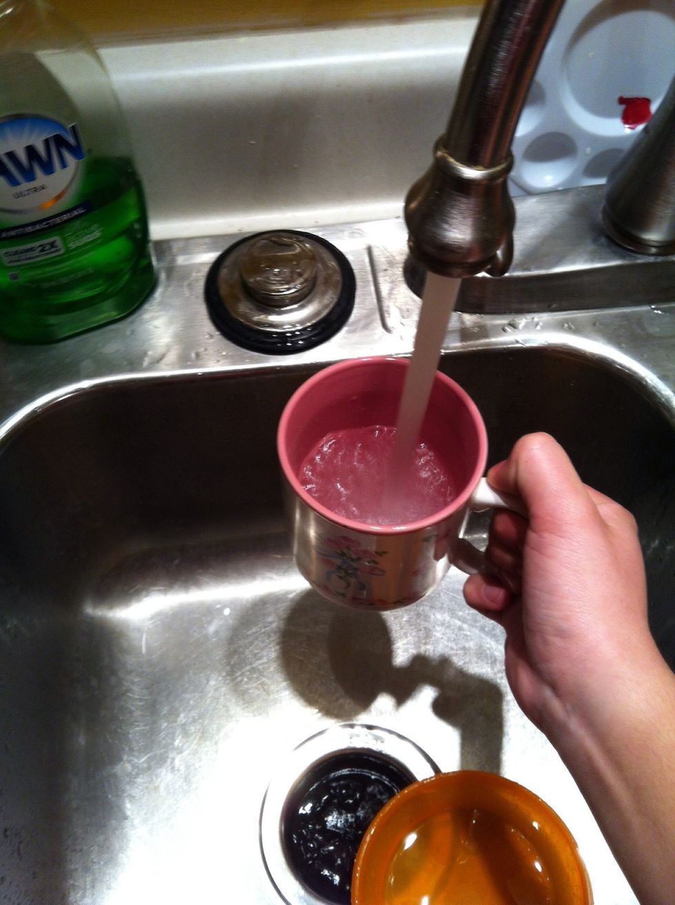 Fill the mug half way up with hot water.