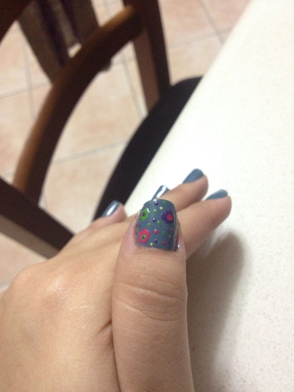 Fill the nail with another flower (or two, or three... Depending on how long your nail is...) and add some dots around it in multi-colors