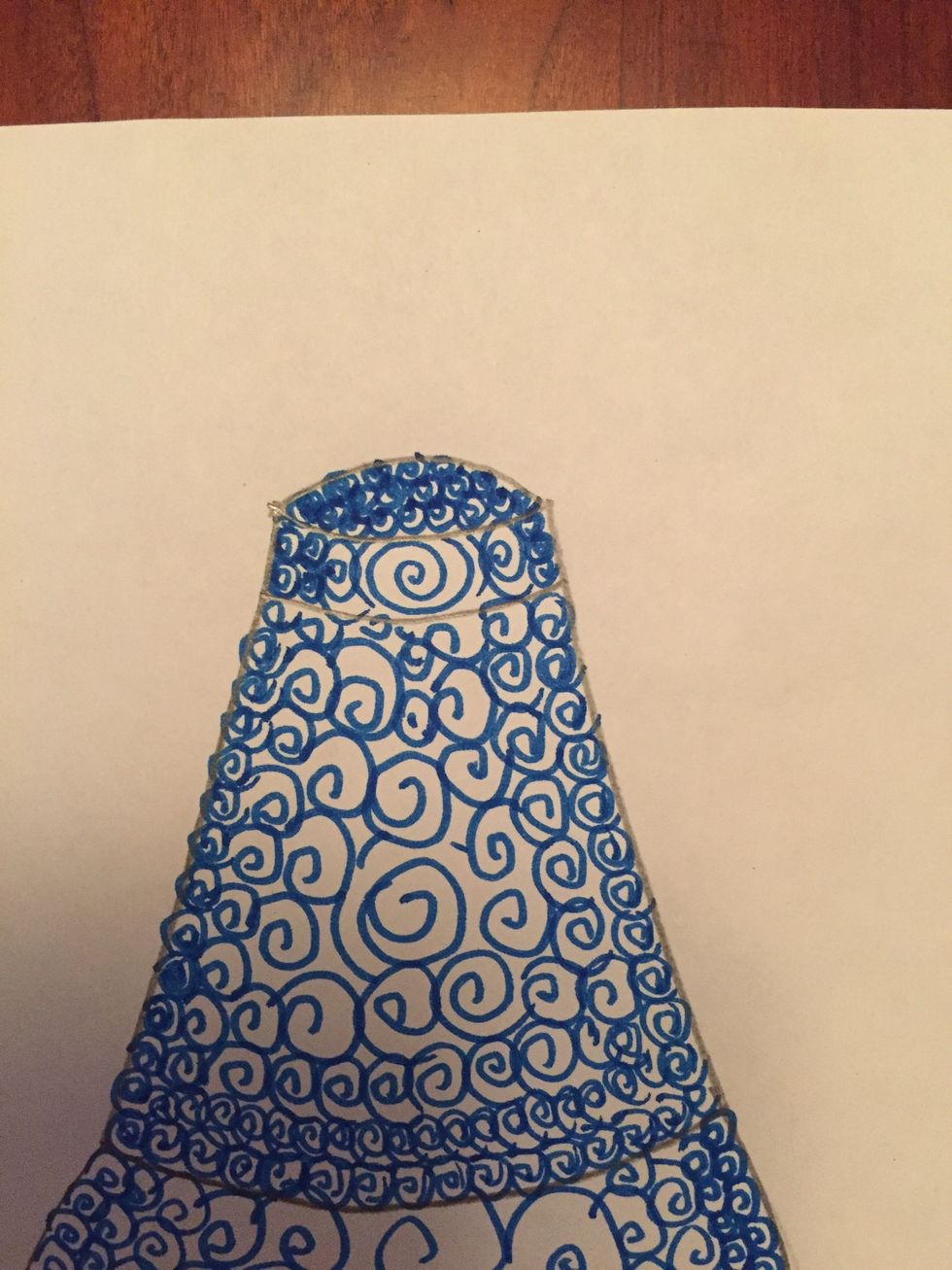 Fill the opening at the top with small shapes or symbols. The opening is all shadow, dark value.