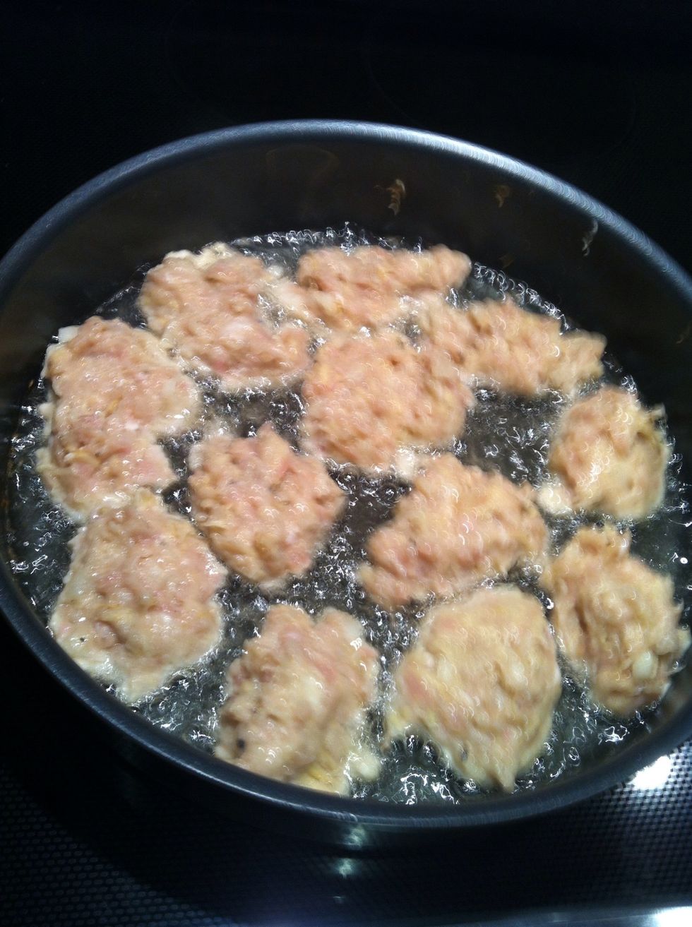 Fill the pan quickly by scooping the mixture with one spoon then using a second spoon to push the mixture into the hot oil.