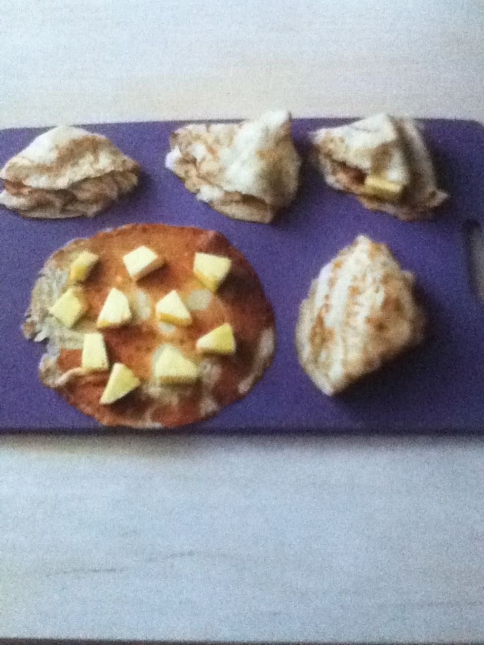 Fill the pancakes with pieces of pineapple and fold into fan shapes to serve