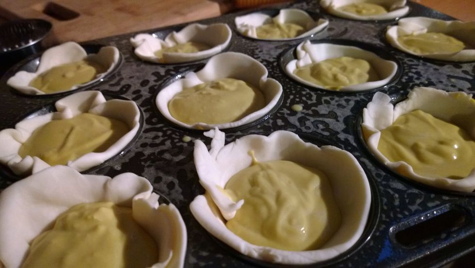 Fill the pastry cups 3/4 of the way up. By now your custard mix should be cool enough to use. Remember we put it in a cold water bath earlier. That helps us work a lot faster. :)