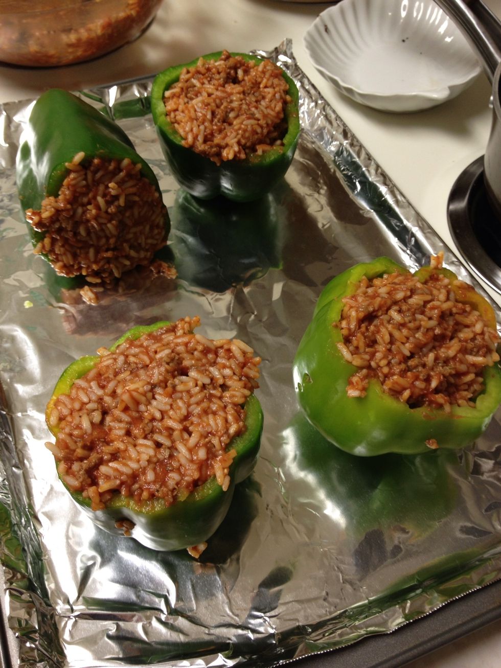 Fill the peppers with the meat and rice mixture, place on a cookie sheet (foil makes for an easy clean up), and bake for 25 minutes.