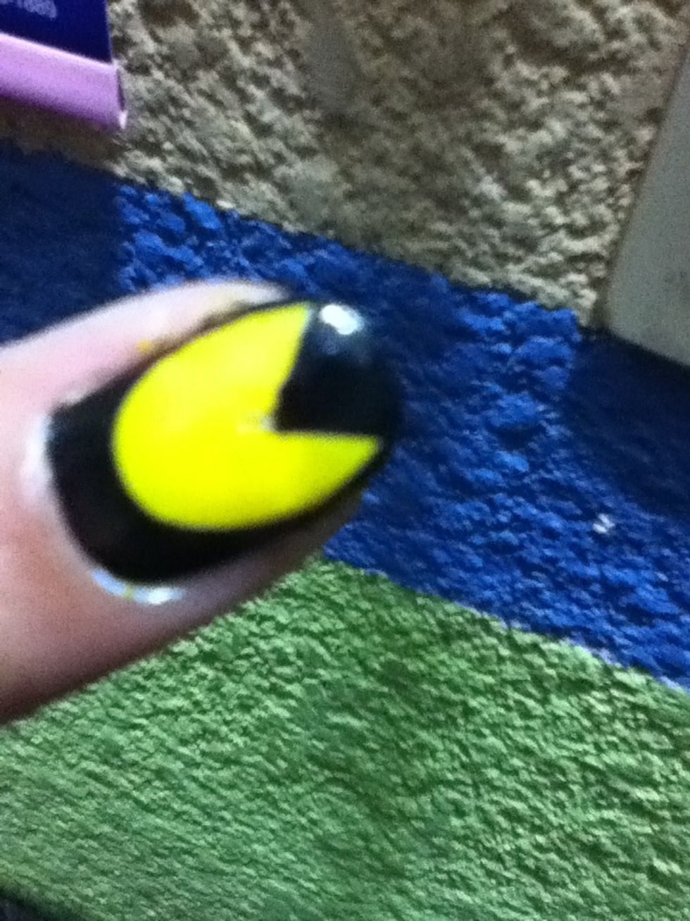 Fill the rest of the nail with black nail polish and you already have your pacman